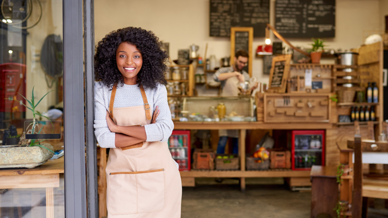 Smiling small business owner using a tablet, illustrating the convenience and key benefits of banking with Bank of St. Croix.